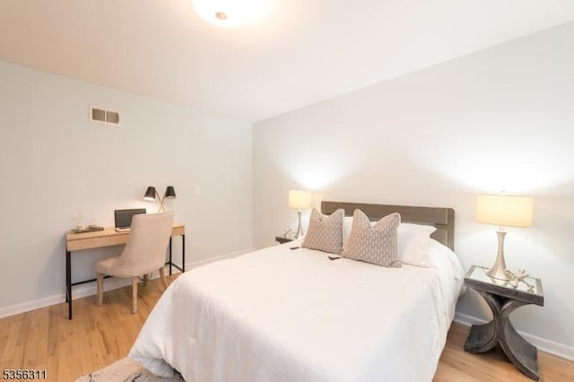 bedroom featuring light wood-style floors and baseboards