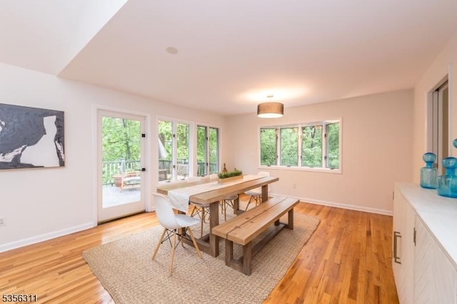 dining room with light wood-style flooring and baseboards