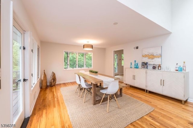 dining space with light wood-style floors and baseboards