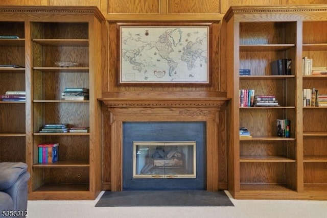 living area with a fireplace with flush hearth
