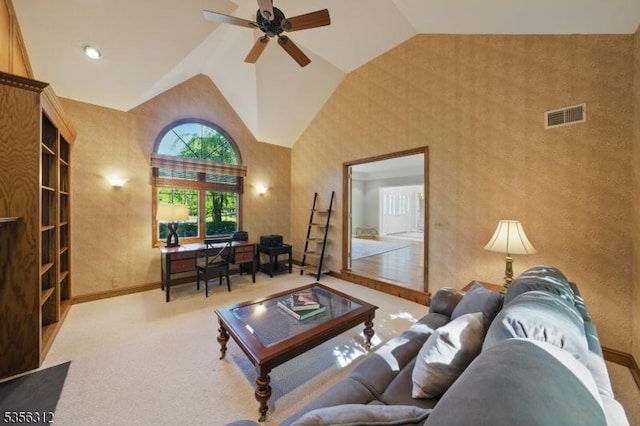 living area with a ceiling fan, baseboards, high vaulted ceiling, and carpet floors