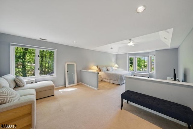 bedroom featuring light colored carpet, a raised ceiling, baseboards, a ceiling fan, and recessed lighting