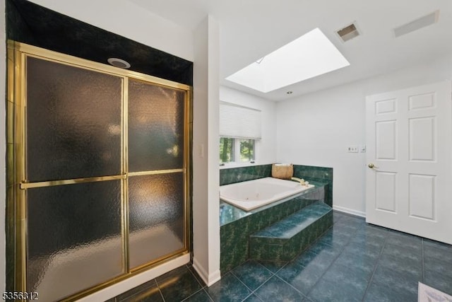 bathroom featuring a skylight, tile patterned flooring, and a shower stall