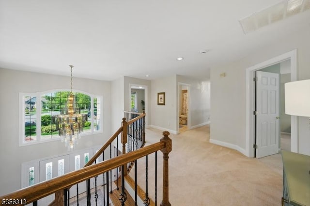 hallway featuring an upstairs landing, a chandelier, light carpet, baseboards, and recessed lighting