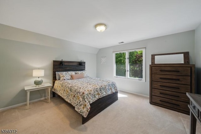 bedroom with light carpet and baseboards