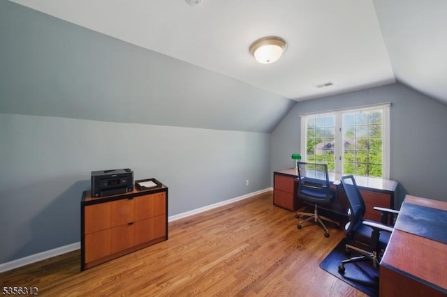 office with wood finished floors, vaulted ceiling, and baseboards