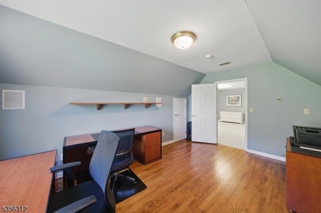 office area featuring wood finished floors and vaulted ceiling