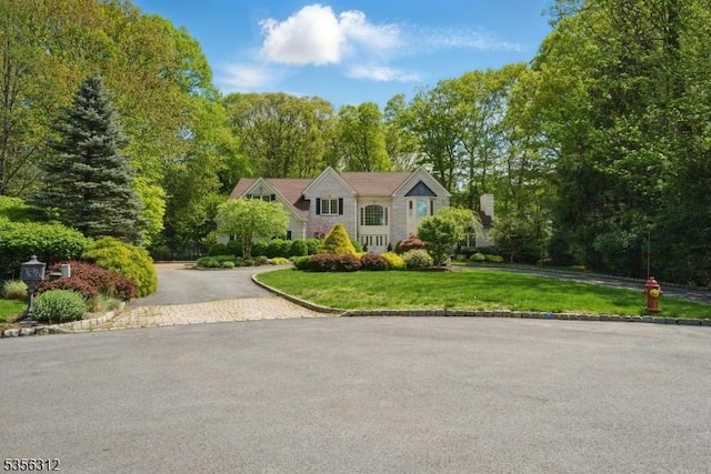 raised ranch with a front yard and driveway
