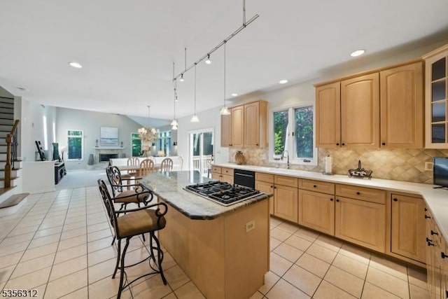 kitchen with stainless steel gas cooktop, light tile patterned flooring, open floor plan, decorative backsplash, and recessed lighting