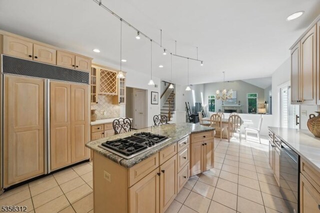 kitchen with paneled refrigerator, light brown cabinets, gas cooktop, light tile patterned flooring, and recessed lighting