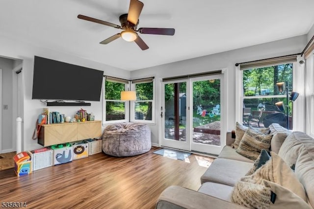 living room featuring wood finished floors and a ceiling fan