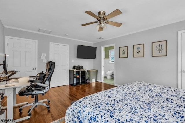 bedroom featuring wood finished floors, crown molding, an office area, ceiling fan, and baseboards