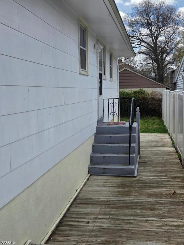 wooden terrace featuring fence
