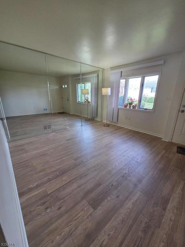 empty room featuring wood finished floors and baseboards