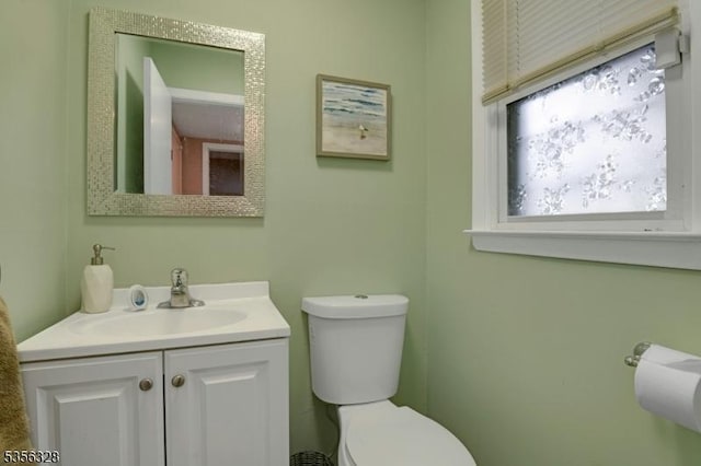 bathroom featuring toilet and vanity