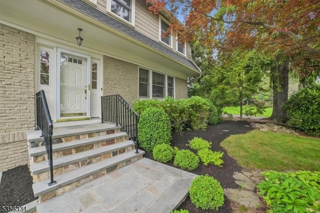 property entrance with brick siding