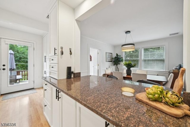 kitchen with white cabinetry and plenty of natural light