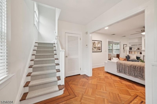 staircase with a ceiling fan, baseboards, and recessed lighting