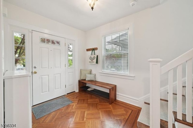 entryway with stairs and baseboards