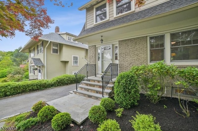 view of exterior entry featuring a patio and stucco siding