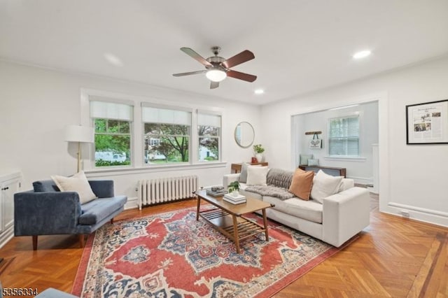 living room featuring radiator heating unit, plenty of natural light, a ceiling fan, recessed lighting, and baseboards