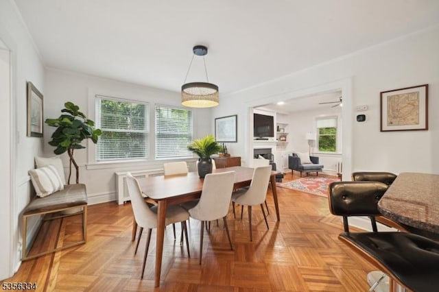 dining space featuring plenty of natural light, crown molding, and baseboards
