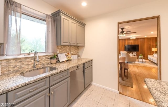 kitchen with dishwasher, gray cabinetry, a sink, decorative backsplash, and recessed lighting