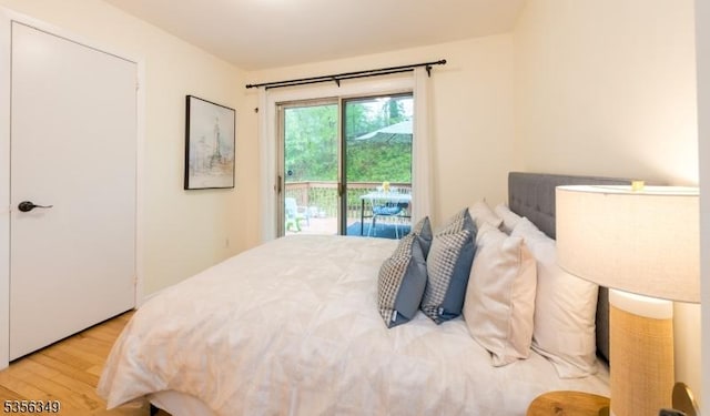 bedroom featuring access to exterior and wood finished floors