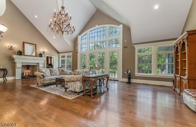 152 Whitebridge Rd, Franklin Twp, NJ 08867 - living room featuring wood finished floors, high vaulted ceiling, a lit fireplace, baseboards, and a chandelier