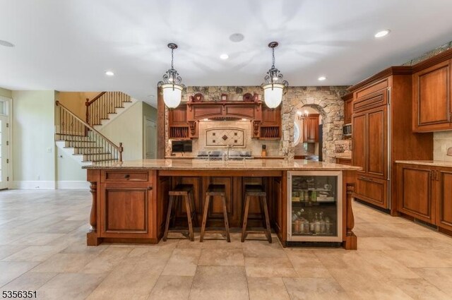 152 Whitebridge Rd, Franklin Twp, NJ 08867 - bar area with beverage cooler, arched walkways, decorative light fixtures, paneled refrigerator, and recessed lighting