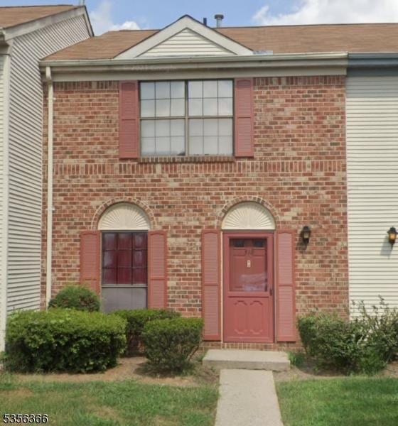 doorway to property with brick siding
