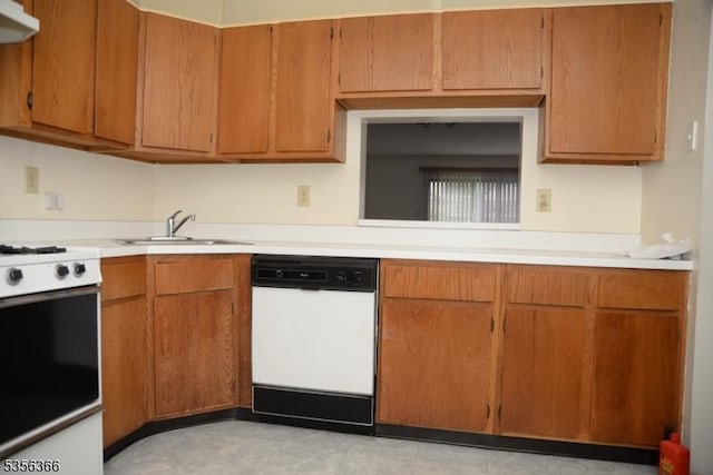 kitchen with white appliances, light countertops, a sink, brown cabinets, and under cabinet range hood