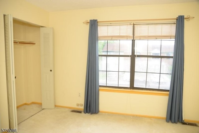 unfurnished bedroom with carpet flooring, a closet, and baseboards