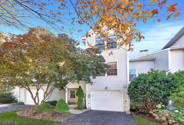 view of front of home featuring asphalt driveway and an attached garage