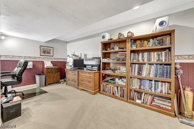 office with light carpet and a wainscoted wall