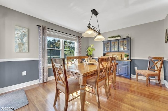 dining room featuring light wood-style floors and baseboards