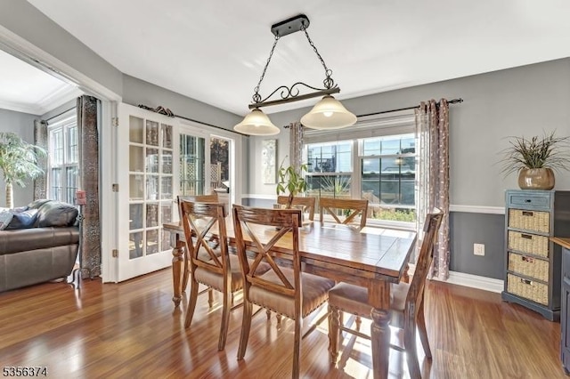 dining room with plenty of natural light, wood finished floors, and baseboards
