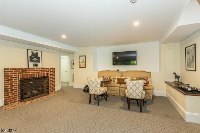 living room with carpet floors, baseboards, recessed lighting, and a brick fireplace