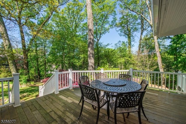 wooden terrace with outdoor dining space