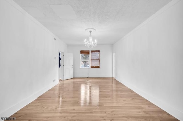 797 Passaic Ave, West Caldwell Twp, NJ 07006 - unfurnished dining area featuring a chandelier, crown molding, wood finished floors, a textured ceiling, and baseboards