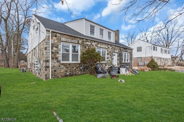 797 Passaic Ave, West Caldwell Twp, NJ 07006 - back of house with stone siding and a lawn