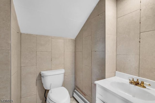 797 Passaic Ave, West Caldwell Twp, NJ 07006 - half bathroom featuring tile walls, a baseboard heating unit, lofted ceiling, toilet, and vanity
