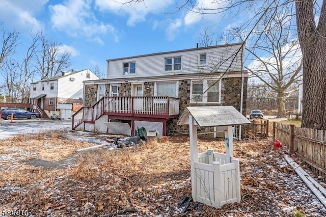 797 Passaic Ave, West Caldwell Twp, NJ 07006 - rear view of property featuring stone siding, fence, and a deck