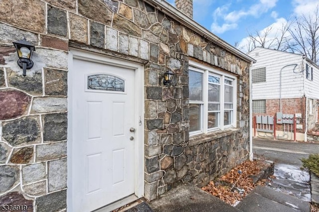 797 Passaic Ave, West Caldwell Twp, NJ 07006 - property entrance with stone siding and a chimney
