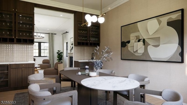 dining room featuring a chandelier, crown molding, and light wood-type flooring