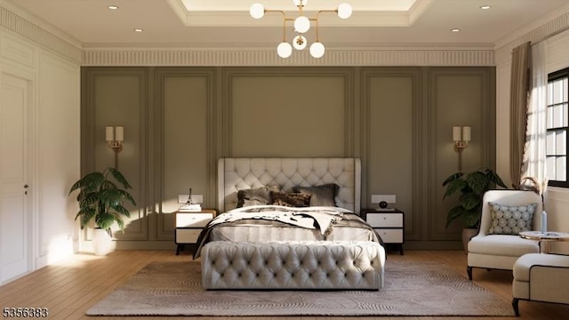 bedroom featuring light wood finished floors, ornamental molding, and a chandelier