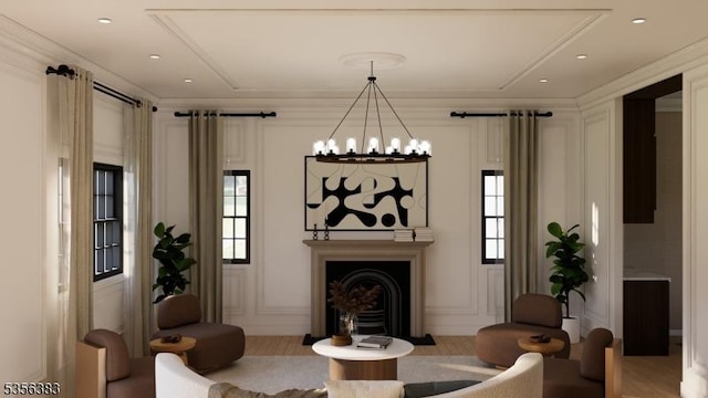 living area with a fireplace with flush hearth, plenty of natural light, a chandelier, and wood finished floors