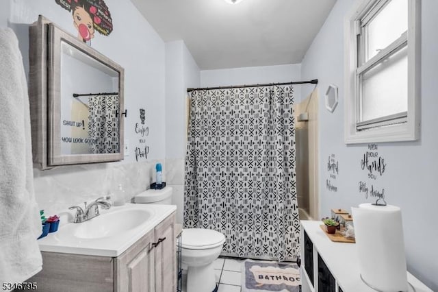 full bath featuring vanity, toilet, tile patterned flooring, and tile walls