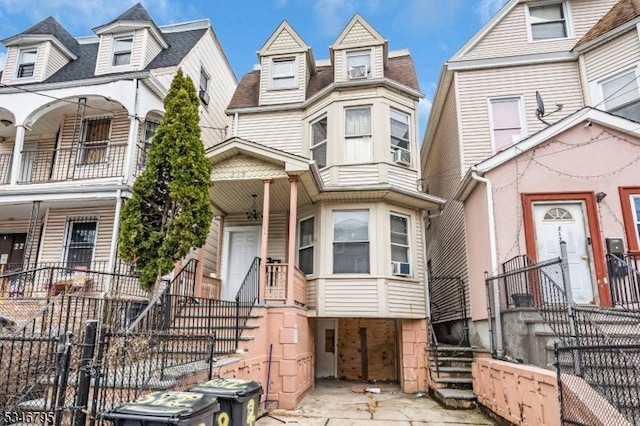 view of front facade with a fenced front yard and stairway