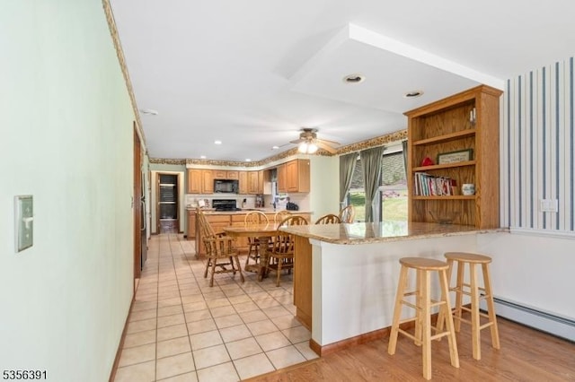 75 Wolfs Corner Rd, Green Twp, NJ 07860 - kitchen featuring black microwave, a peninsula, a breakfast bar area, ceiling fan, and open shelves